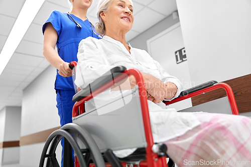 Image of nurse with senior patient in wheelchair at clinic