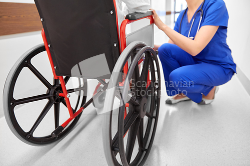 Image of nurse with senior patient in wheelchair at clinic