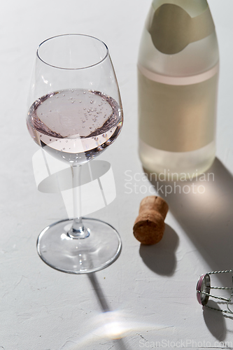 Image of wine glasses and champagne bottle dropping shadows