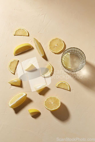 Image of glass of water and lemon slices on table