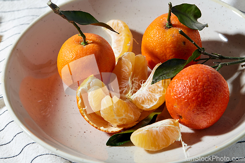 Image of still life with mandarins on plate over drapery