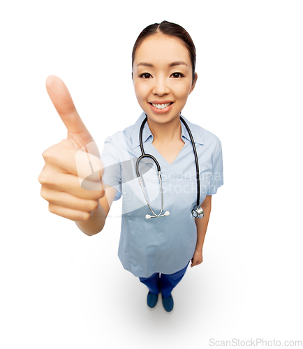 Image of smiling asian female doctor showing thumbs up