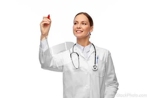 Image of happy female doctor writing with red marker