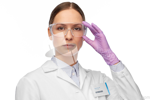 Image of female scientist in goggles and gloves