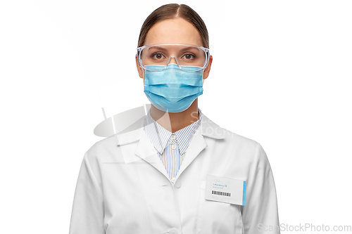 Image of female scientist in medical mask and goggles