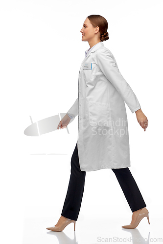 Image of smiling female doctor or scientist walking