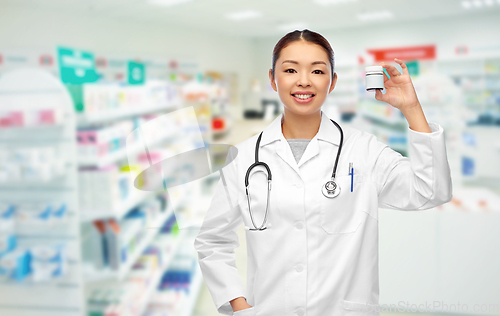 Image of asian female doctor with medicine at pharmacy