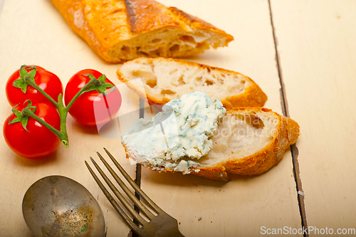 Image of fresh blue cheese spread ove french baguette