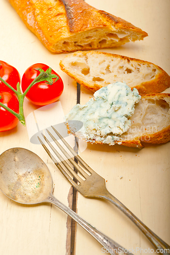 Image of fresh blue cheese spread ove french baguette