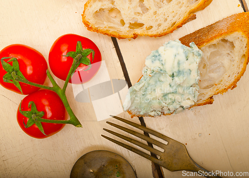 Image of fresh blue cheese spread ove french baguette