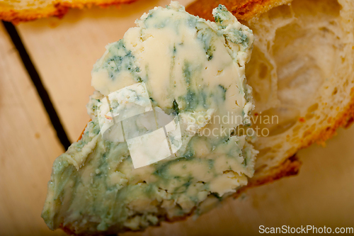 Image of fresh blue cheese spread ove french baguette