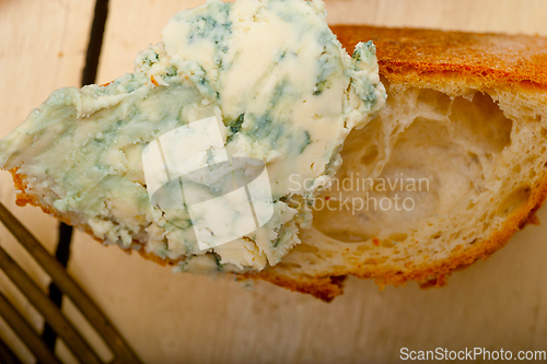 Image of fresh blue cheese spread ove french baguette