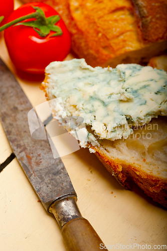 Image of fresh blue cheese spread ove french baguette