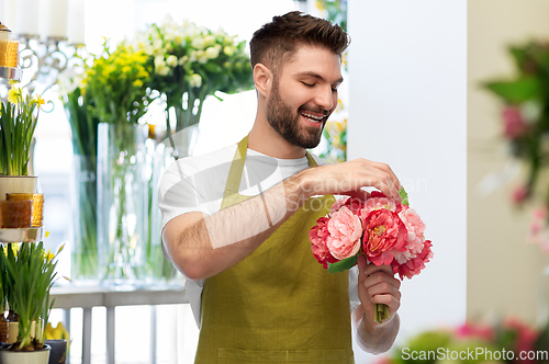 Image of smiling male florist or seller at flower shop