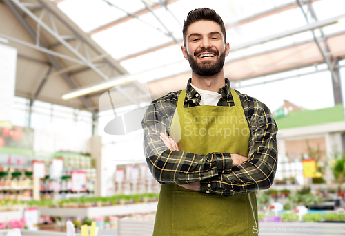 Image of happy male gardener or seller at flower shop