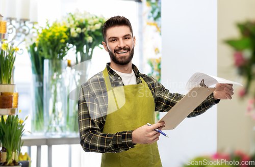 Image of male gardener with clipboard at flower shop