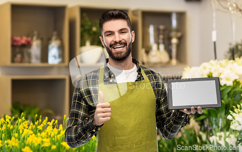 Image of flower seller with tablet pc shows thumbs up