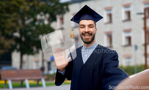 Image of smiling male graduate student taking selfie