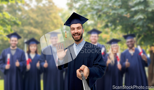 Image of male graduate student taking selfie with monopod