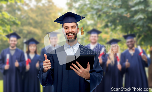 Image of male graduate student or bachelor with tablet pc