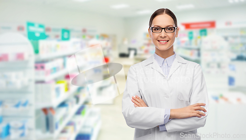 Image of happy female pharmacist or doctor over pharmacy