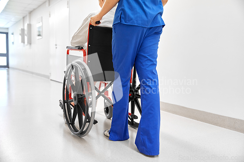 Image of nurse with senior patient in wheelchair at clinic