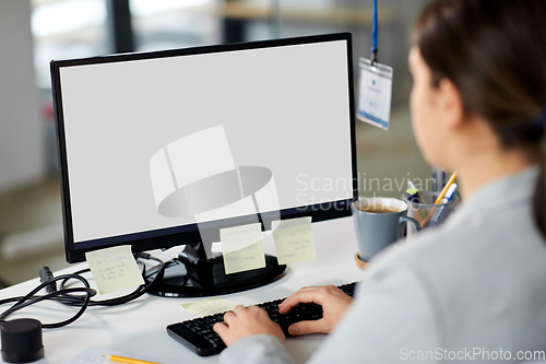 Image of businesswoman with computer working at office