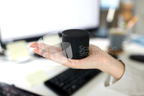 Image of businesswoman using smart speaker at office