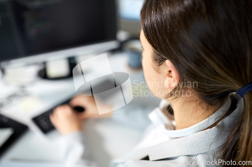 Image of businesswoman with computer working at office