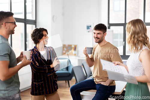 Image of team of startuppers drinking coffee at office