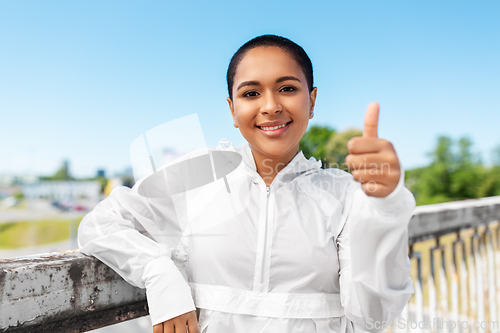 Image of sporty african american woman showing thumbs up