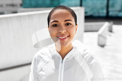 Image of african american woman in sports clothes outdoors