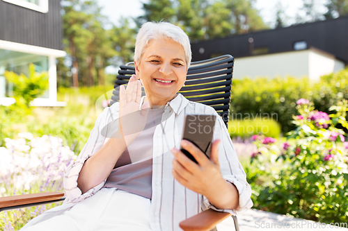 Image of happy senior woman with phone having video call