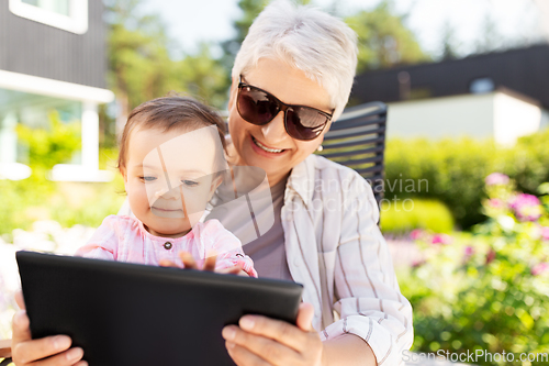 Image of grandmother and baby granddaughter with tablet pc