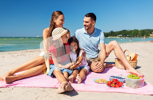 Image of happy family having picnic on summer beach