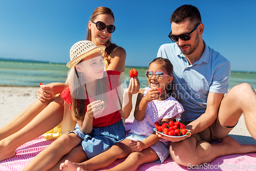 Image of happy family having picnic on summer beach