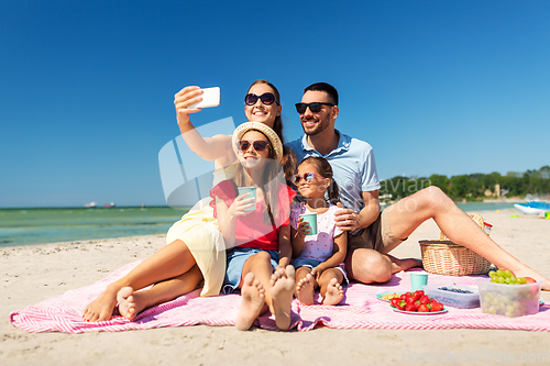 Image of happy family taking selfie on summer beach