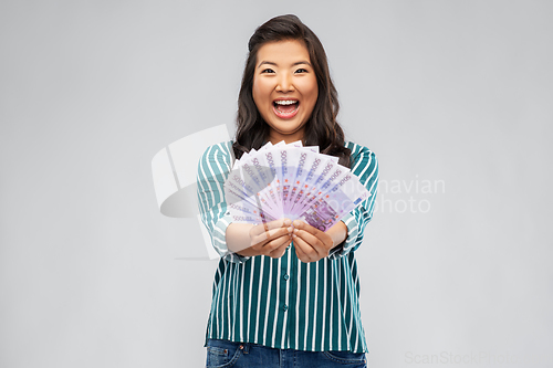 Image of asian woman with money banknotes of thousands euro