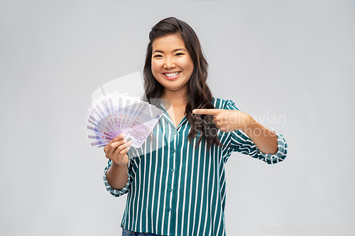 Image of asian woman with money banknotes of thousands euro