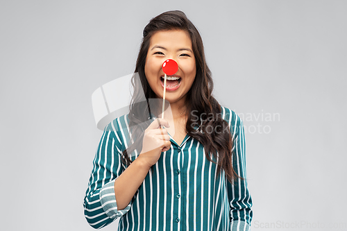 Image of happy asian woman with red clown nose