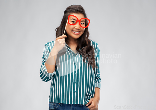 Image of happy asian woman with big party glasses