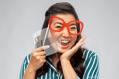 Image of happy asian woman with big party glasses