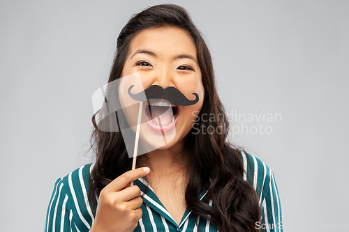 Image of asian woman with vintage moustaches party prop