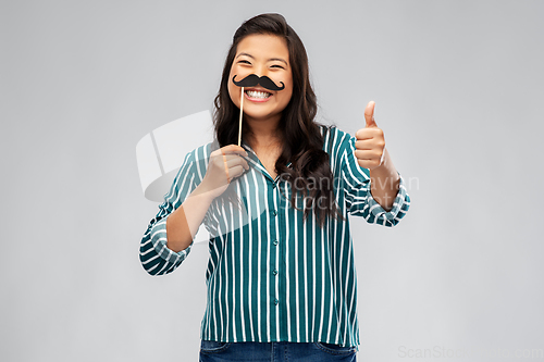 Image of asian woman with vintage moustaches party prop