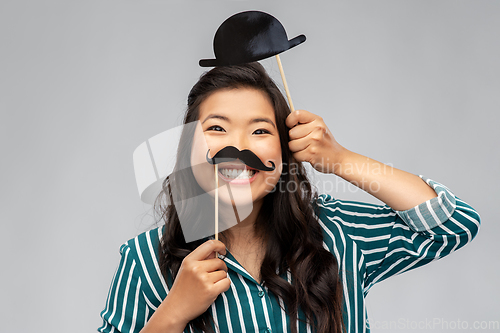 Image of asian woman with vintage moustaches and bowler hat