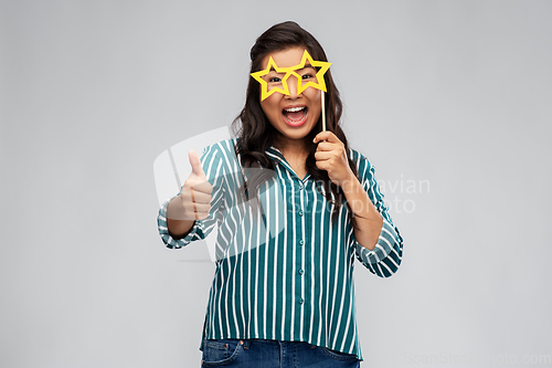 Image of happy woman with party glasses showing thumbs up