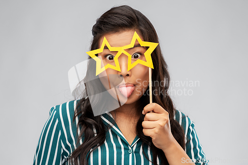 Image of happy asian woman with star-shaped party glasses