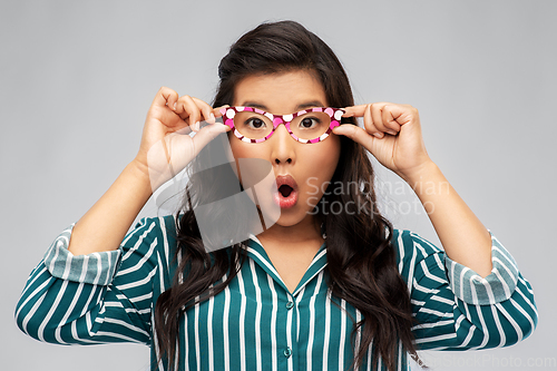 Image of surprised asian woman with party glasses