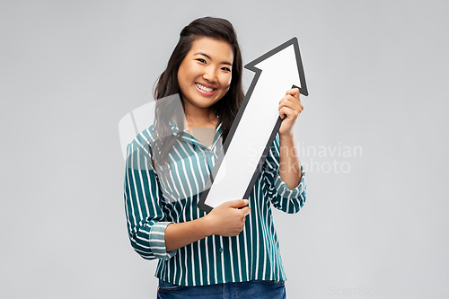 Image of happy smiling asian woman with arrow pointing up