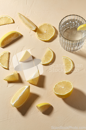 Image of glass of water and lemon slices on table